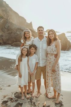 a family poses for a photo on the beach