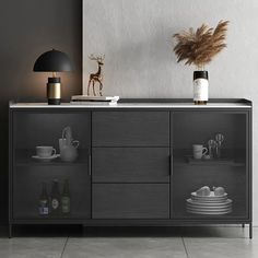 a sideboard with glass doors and shelves filled with plates, cups and vases