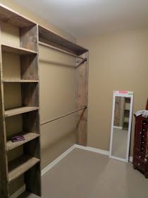 an empty room with some shelves and a mirror