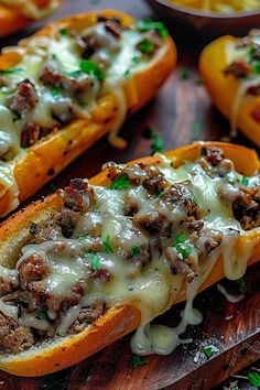 several stuffed peppers with cheese and meat on them