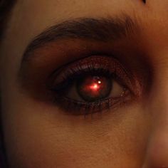 a woman's eye with red eyeshadow