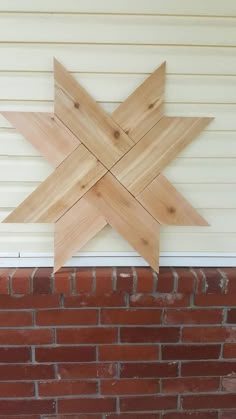 a wooden star hanging on the side of a building