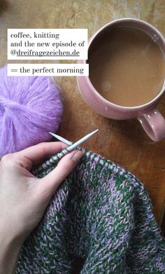 someone is knitting on the table next to a cup of coffee