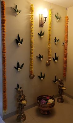 the wall is decorated with flowers and hanging from it's sides, along with candles