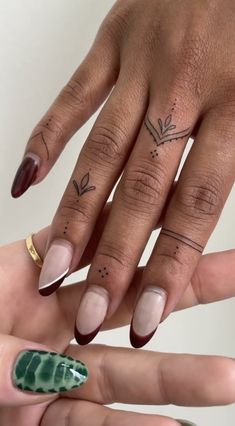 two hands with different designs on their fingers