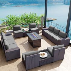 an outdoor living area with wicker furniture and water view in the backround