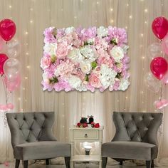 two gray chairs with pink and white flowers on the wall next to each other in front of balloons