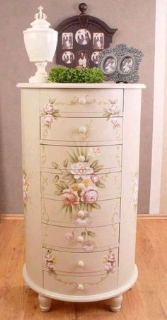 a white dresser with flowers painted on it