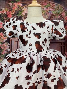 This gorgeous handcrafted cowgirl dress is made out of cotton material; Brown cow print cotton material covers the dress from top to bottom. The back of the bodice has a v-cut with a closing zipper. This country style dress comes with a detachable mini sequin bow. Satin cow print skirt comes with two layers of tulle to create shape. Underneath the tulle is a layer of lining and another layer of lining under all with attached crinoline. It is great for any occasion: birthday, wedding, graduation, Country Style Dresses, Toddler Flower Girl, Brown Cow Print, Flower Girl Wedding, Toddler Flower Girls, Cowgirl Dresses, Toddler Birthday Party, Party Photoshoot, Brown Cow