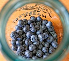 blueberries in a mason jar on a wooden table