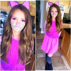 a girl in pink dress with cat ears on her head and teeth painted on her face