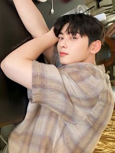 a young man sitting on top of a bed next to a hair dryer and blow dryer