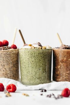 three different types of chia pudding in cups with strawberries and raspberries on the side