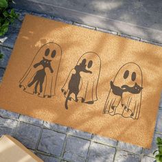 a door mat with three cartoon figures on it