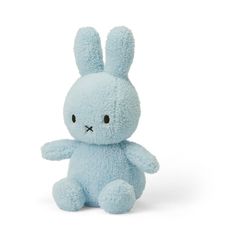 a blue stuffed animal sitting on top of a white surface