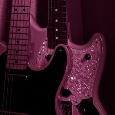 two electric guitars sitting next to each other on a purple background with black and white details