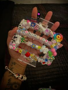 a person holding several different bracelets in their hand with the letter e on them