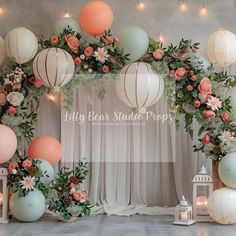 the backdrop is decorated with balloons and flowers