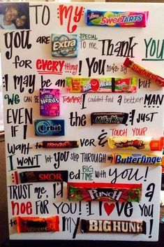 a refrigerator decorated with candy bar magnets and writing on the fridge's side