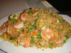 rice with shrimp and peas on a white plate