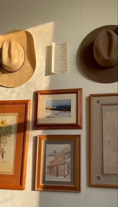 a wall with pictures and hats hanging on it