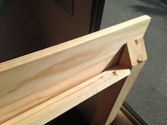 a piece of wood sitting on top of a wooden shelf