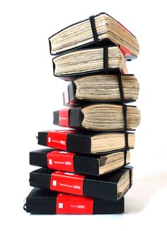 a stack of books sitting on top of each other in front of a white background