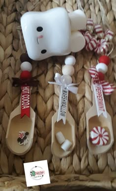 the hello kitty spoons are decorated with candy canes and marshmallows