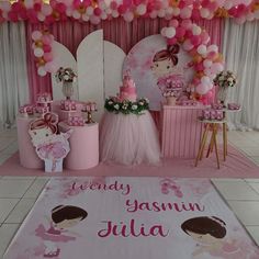 a pink birthday party with balloons and decorations