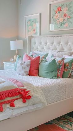 a white bed topped with lots of pillows