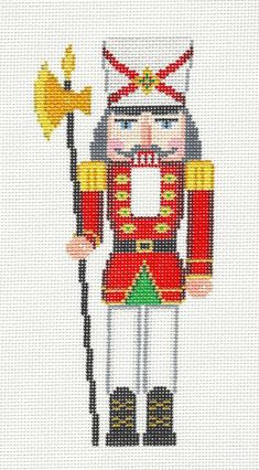 a cross stitch pattern of a nutcracker holding a yellow flag and wearing a red hat