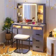 a vanity with lights on and a stool in front of it, next to a christmas tree