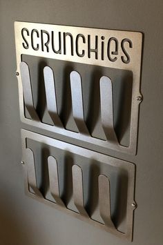 a metal sign that reads scrunchies on it's side hanging from the wall