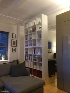 a living room filled with furniture and bookshelves