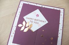 a purple card with gold foil flowers on it and the words happy birthday to you