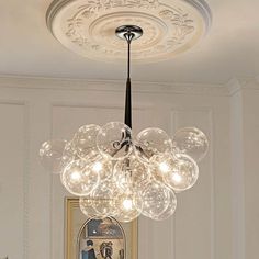 a chandelier hanging from the ceiling in a room