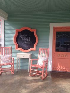 three rocking chairs sitting outside of a house with a chalkboard on the front door