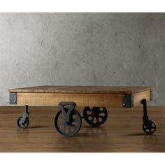 three black wheels sit on top of a wooden table