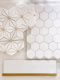 some white and gold tiles are next to each other