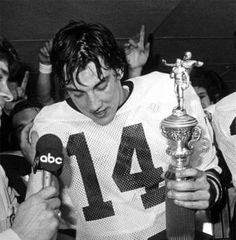 the football players are holding their trophy and talking to each other in front of an audience