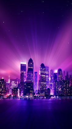 the city skyline is lit up with purple light and bright beams in the sky above it