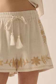 Linen-blend shorts. Floral embroidery. Elastic waist with tassel drawstring. Side pockets. Wide leg. Thigh length. Relaxed fit. 70% Rayon, 30% Linen. Imported. Designed in LA. Model wears size S. Floral Embroidery, Appliques, Linen Blend, Elastic Waist, Wide Leg, Relaxed Fit, Embroidery, Elastic, Floral