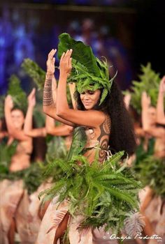 a group of women dressed in leafy outfits