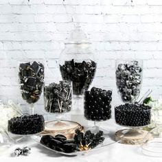 a table topped with lots of black and white candies