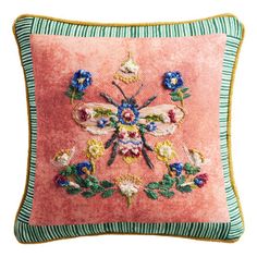 an embroidered pillow with flowers on it