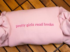 Celebrate your love for books with our Pretty Girls Read Books Embroidered Sweatshirt! This stylish and cozy bookish crewneck is perfect for bookworms and avid readers. Featuring minimalist embroidery, it's a great way to show off your passion for reading in a fun and fashionable way. Whether you're gifting it to a book lover or adding it to your own collection, this custom sweatshirt is the perfect piece for lounging with your favorite novel, attending book club, or casual outings. Thoughtful and personalized, it makes an ideal gift for her, whether for birthdays, holidays, or any occasion. Message me with any questions you might have :) I recommend sizing up a size or two for an oversized fit! Bookish Ideas, Bookish Crewneck, Minimalist Embroidery, Minimalist Book, Sweatshirts Quotes, Favorite Novels, Girl Reading, Custom Sweatshirts, Embroidered Sweatshirt