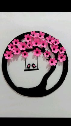 this is an image of a tree with flowers in the shape of a bird on a swing