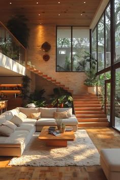 a living room filled with lots of furniture next to a stair case in front of a window