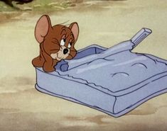 a cartoon mouse in a suitcase on the ground