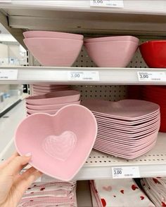 the shelves are filled with heart shaped dishes